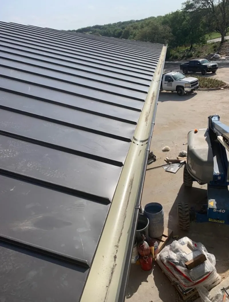 Standing seam panel and gutter detail on a metal roofing jobsite in Four Corners